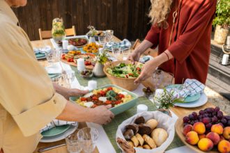 Woman Putting Dishes on Table